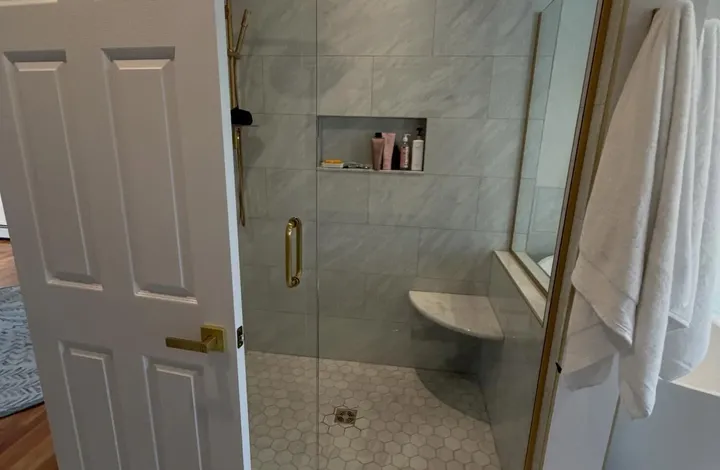 Tiled walk-in shower seen from the bathroom doorway