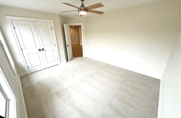 Wide view of a finished bedroom carpet installation
