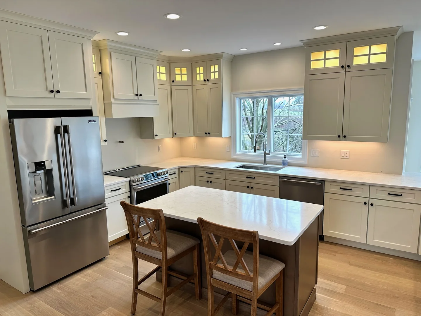 Completed River's Edge kitchen remodel with white cabinetry and a quartz island