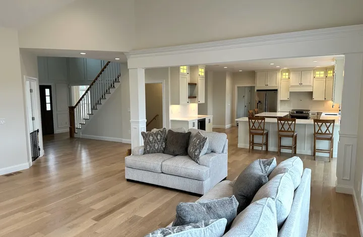Open-concept living room and kitchen with hardwood floors, a completed River's Edge Home Center project